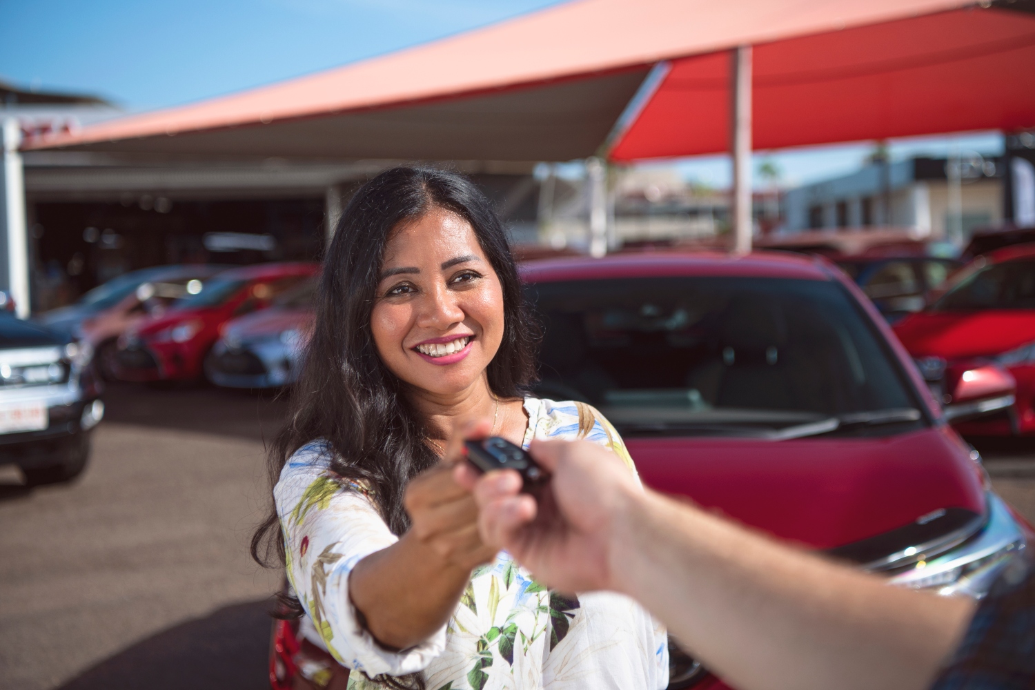 Woman receiving keys to a new car