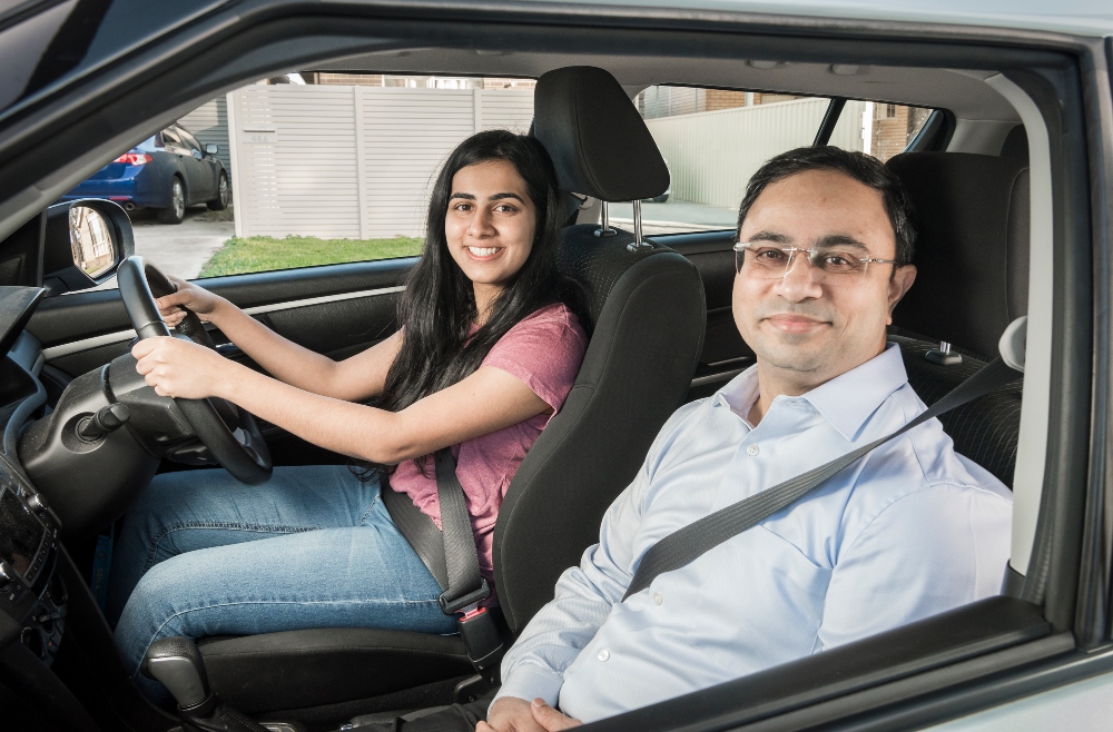 Dad teaching his daughter to drive 