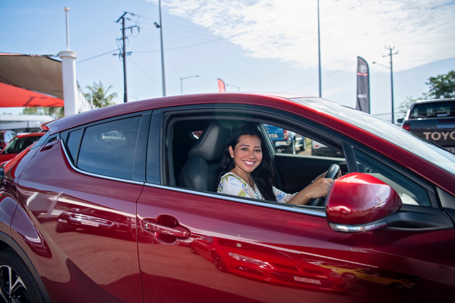 Woman smiling in her car