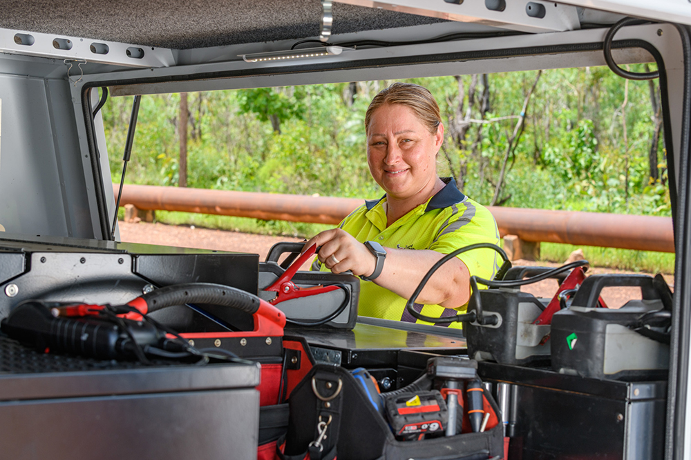 Woman testing a car battery