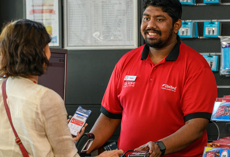 Woman scanning AANT app to redeem the 6c per litre fuel discount