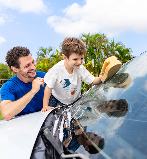 Dad and son washing car together