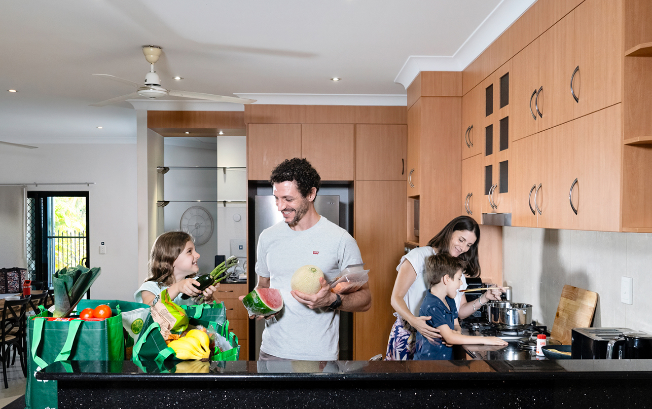 Family unpacking grocery shopping in the kitchen