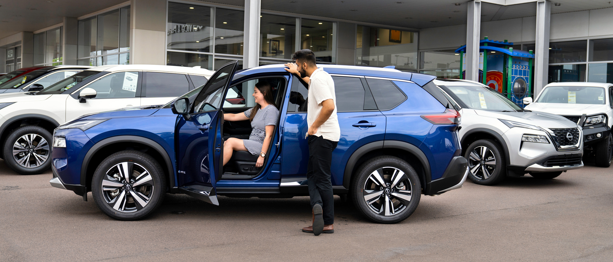 Couple looking at new car in a car dealership