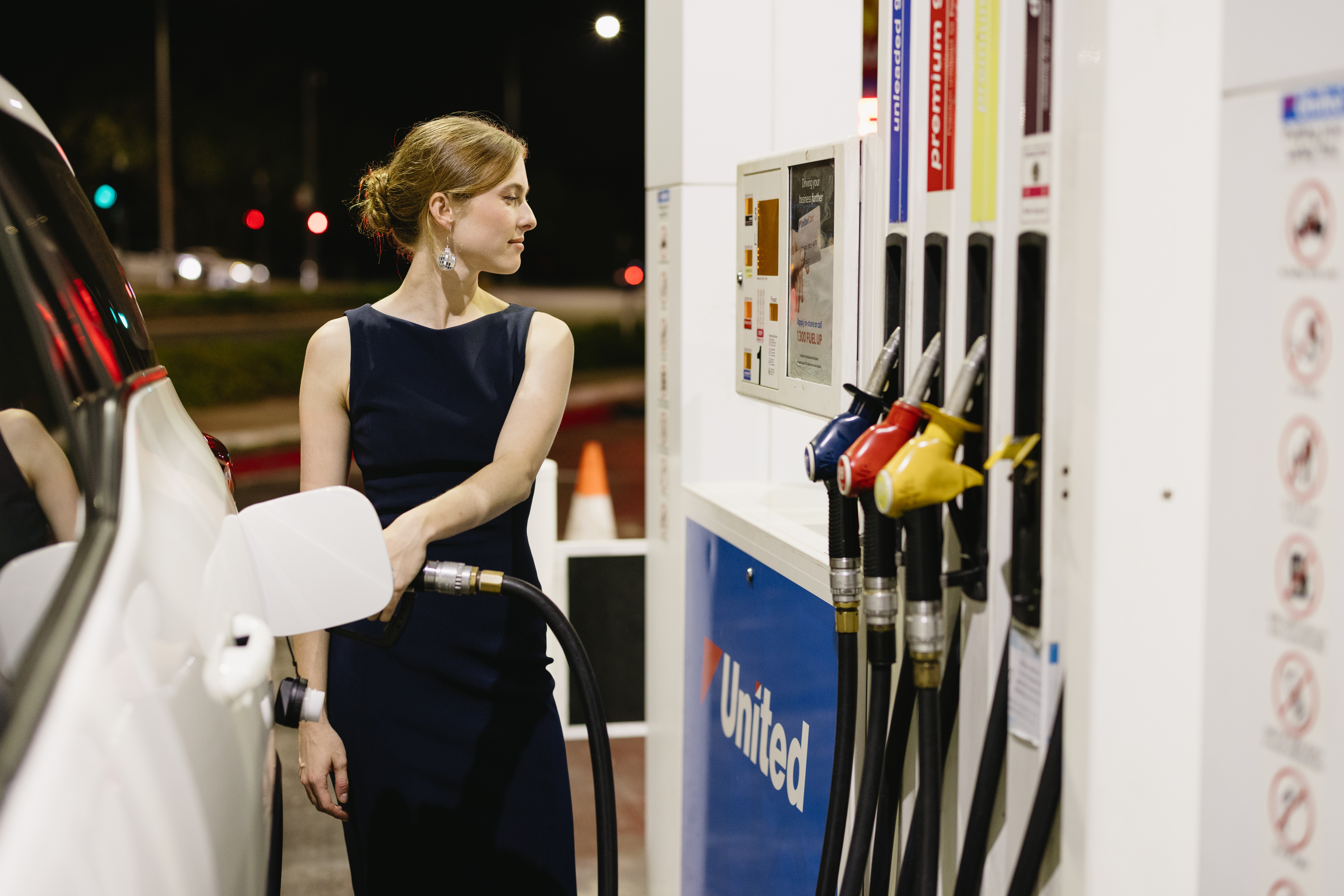 Woman filling her car up at United fuel station