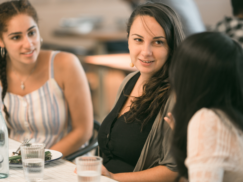 Employees talking over lunch 