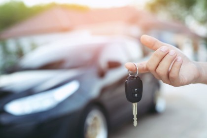 Person holding up a car key