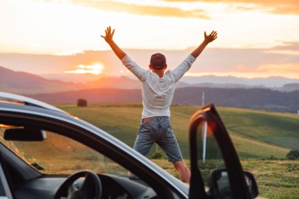 Man jumping for joy with his new car