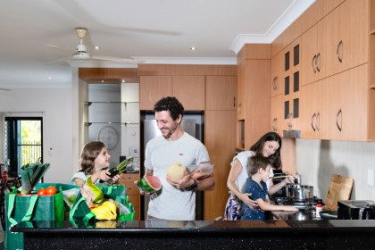 Family unpacking grocery shopping in the kitchen