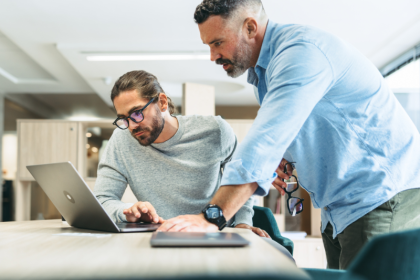 Two men reviewing something on the computer