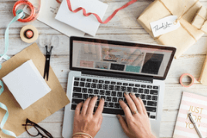 eGift Card hands typing on a laptop