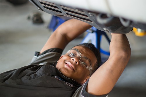 Young mechanic working on a car