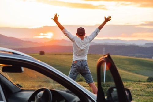 Man jumping for joy with his new car