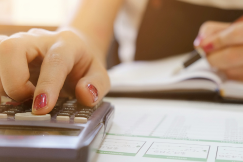 Person doing calculations on a calculator  