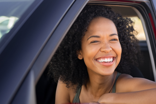 Young woman smiling in a car 